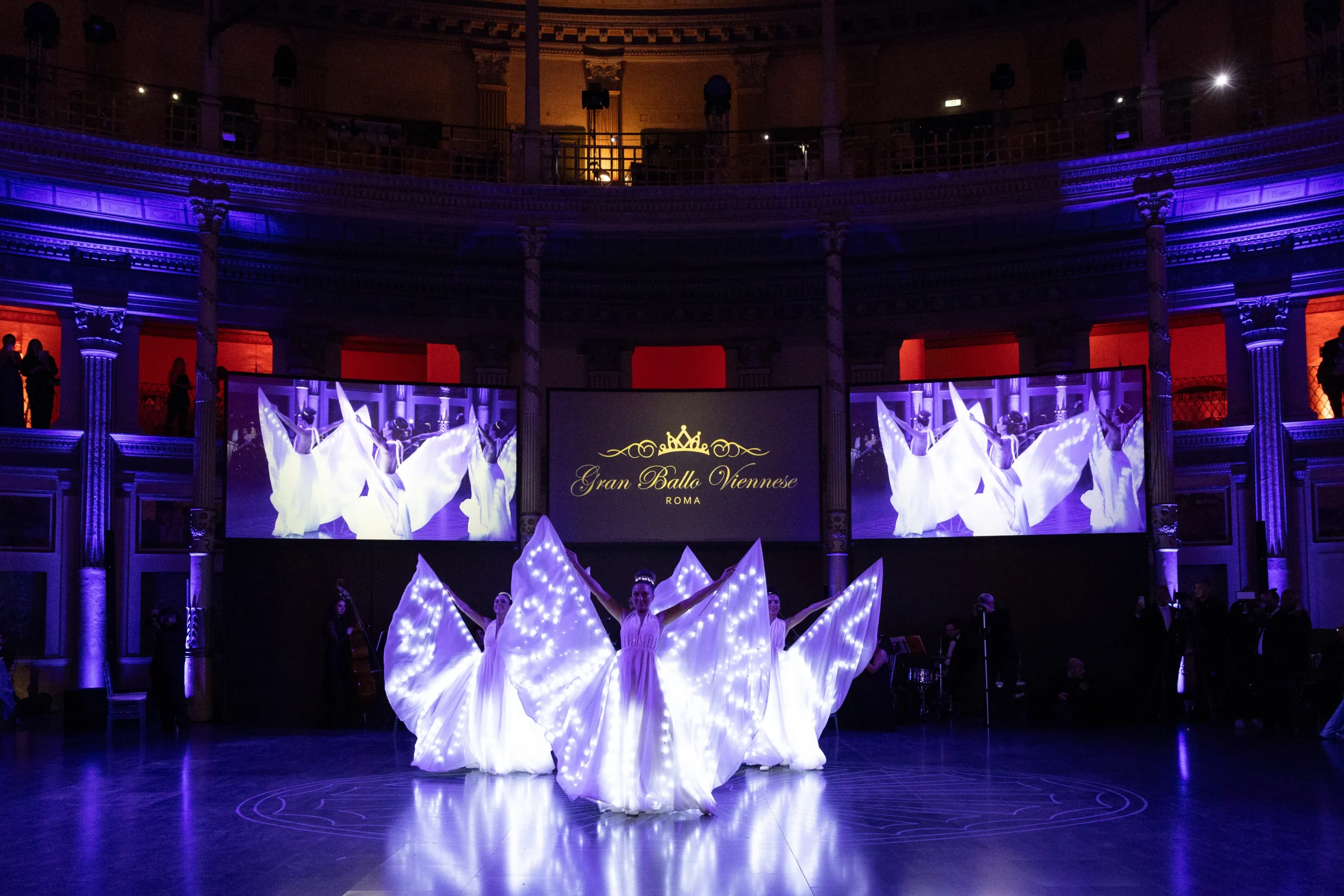 Dettaglio dei costumi delle farfalle luminose durante la performance al Gran Ballo delle Debuttanti.